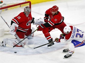 Hurricanes' Jordan Staal (11) attempts to clear the puck in front of goalie Cam Ward with Canadiens' Alex Galchenyuk nearby during third period Wednesday night in Raleigh, N.C.