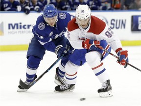 Montreal Canadiens center Jonathan Drouin (92) moves the puck in front of Tampa Bay Lightning centre Brayden Point (21) during the first period Thursday in Tampa. “We know points are slipping away," Drouin said after facing his former team for the first time.