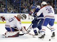 Montreal Canadiens goalie Carey Price (31) makes a save on a shot by Tampa Bay Lightning center Brayden Point (21) during the second period of an NHL hockey game Thursday, Dec. 28, 2017, in Tampa, Fla. Montreal defenseman Brett Lernout (36) keeps Point from a rebound.