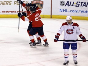 Florida Panthers' Denis Malgin and Vincent Trocheck celebrate after a goal on Saturday, Dec. 30, 2017, in Sunrise, Fla. Canadiens' Tomas Plekanec skates off in dejection.