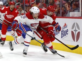 Montreal Canadiens' Jacob De La Rose and Detroit Red Wings defenceman Xavier Ouellet battle for the puck in the third period on Thursday, Nov. 30, 2017, in Detroit.