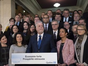 Quebec Premier Philippe Couillard holds a news conference along with members of his caucus at the end of session at the National Assembly in Quebec City Friday, December 8, 2017.