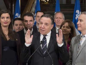 Coalition Avenir Quebec Leader Francois Legault responds to reporters questions during the end of session new conference at the National Assembly in Quebec City Friday, December 8, 2017 . Legault is flanked by Genevieve Guilbault, from the left to right, Simon Jolin Barrette, Francois Bonnardel, Jean-Francois Roberge, Andre Lamontagne, Nathalie Roy and Eric Lefebvre.
