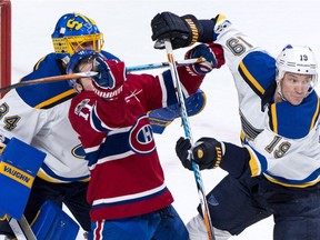 Montreal Canadiens' Brendan Gallagher (11) crosses sticks with St. Louis Blues defenceman Jay Bouwmeester (19) in front of Blues goalie Jake Allen during first period NHL hockey action in Montreal on Tuesday, December 5, 2017.