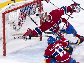 The puck goes into the net past Montreal Canadiens goalie Carey Price on a goal by St. Louis Blues' Scottie Upshall (9) during second period NHL hockey action in Montreal on Tuesday, December 5, 2017.