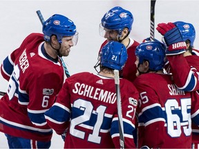 Canadiens' Shea Weber, left, is congratulated by his Canadiens teammates after scoring a second-period goal Tuesday night following an Andrew Shaw faceoff win.