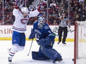 Canadiens' Brendan Gallagher celebrates teammate Daniel Carr's goal past Vancouver Canucks goalie Anders Nilsson in Vancouver on Tuesday, Dec. 19, 2017.