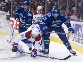 Montreal Canadiens left wing Paul Byron (41) is checked by Vancouver Canucks defenceman Alexander Edler (23) during first period NHL action in Vancouver, Tuesday, Dec. 19, 2017.
