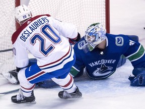 Montreal Canadiens left-wing Nicolas Deslauriers sends a shot past Vancouver Canucks goalie Anders Nilsson  during second period in Vancouver on Tuesday, Dec. 19, 2017.