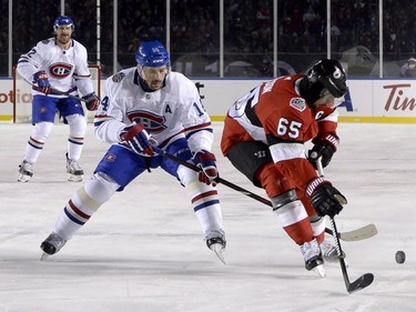 Montreal Canadiens centre Tomas Plekanec tries to steal the puck from Ottawa Senators defenceman Erik Karlsson during first period hockey action at the NHL 100 Classic, on Saturday, Dec. 16, 2017, in Ottawa.