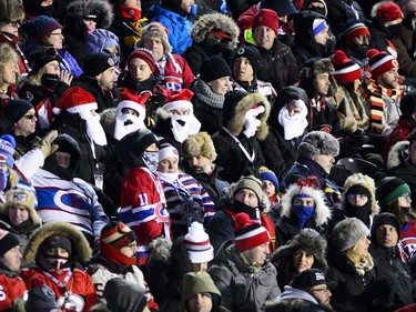 Fans don Santa Claus beards and hats during first period hockey action between the Ottawa Senators and Montreal Canadiens at the NHL 100 Classic, in Ottawa on Saturday, Dec. 16, 2017.