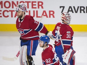 Canadiens goaltender Carey Price (31) touches gloves with backup goalie Antti Niemi after being pulled from the game during  against the Edmonton Oilers in Montreal on Saturday, Dec. 9, 2017.