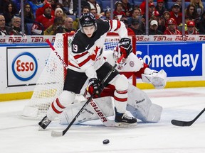 Canada's Drake Batherson goes to the net against Denmark goalie Emil Gransoe during first period IIHF World Junior Championship preliminary action in Buffalo, N.Y., on Saturday, Dec. 30, 2017.