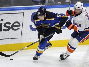 Blues' Colton Parayko, left, skates around Islanders' Josh Bailey, right, during a game last month. The the 6-foot-6, 230-pound defenceman is making a name for himself on the Blues after going undrafted in his first year of eligibility for the NHL draft.