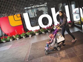 A woman enters a Loblaw store.