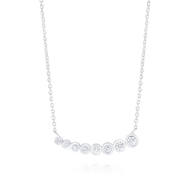 Your star will rise when you give this bezel-set diamond necklace inspired by ascending champagne bubbles. In white or yellow gold. $1,175.