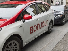 A taxi with Bonjour on the side is seen on Nov. 30 in Montreal. The National Assembly has formally asked Quebec's merchants to "warmly" greet their clients with the word "Bonjour" and drop the old standard "bonjour-hi."
