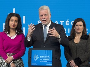 Quebec Premier Philippe Couillard, with Economy, Science and Innovation Minister Dominique Anglade, left, and Justice Minister Stephanie Vallee in Quebec City Dec. 13, 2017.