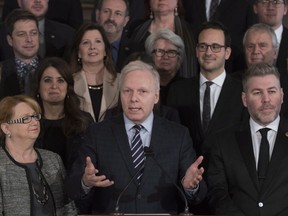Parti Quebecois Leader Jean-Francois Lisee, centre, speaks at a news conference marking the end of the fall session, Friday, December 8, 2017 at the legislature in Quebec City. Members of his caucus look on.