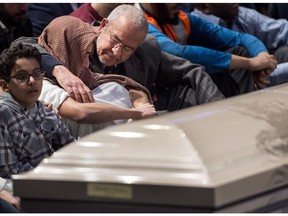 Feb. 3, 2017: Ilies Soufiane is consoled while sitting next to the casket of his father Azzeddine Soufiane.