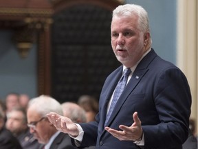 Quebec Premier Philippe Couillard responds to the Opposition, during question period, Tuesday, Dec. 5, 2017 at the legislature in Quebec City.