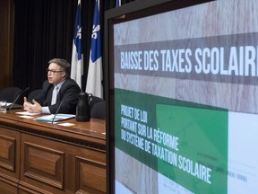 Quebec Education and Family Minister Sebastien Proulx responds to reporters questions after he tabled legislation on school taxation, Thursday, December 7, 2017 at the National Assembly in Quebec City.