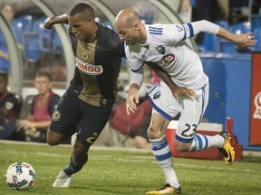 Philadelphia Union's Jay Simpson, left, and Montreal Impact's Laurent Ciman battle for the ball during second half MLS soccer action in Montreal on Wednesday, July 19, 2017.