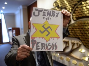 A piece of hate mail is held at a synagogue in Montreal on Tuesday Dec. 19, 2017. B'nai Brith Canada says at least five synagogues across the country have received anti-Semitic hate mail. The various letters call for the genocide of Jewish people, contain the phrase "Jewry Must Perish" and are accompanied by a bleeding Star of David with a swastika in the centre. THE CANADIAN PRESS/Ryan Remiorz