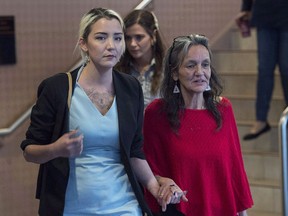 Supporters of an Inuk activist from Labrador suffering from acute liver failure say her condition has improved slightly, but the battle to overturn a six-month sobriety requirement for a spot on a transplant waiting list isn't over. Miriam Saunders, right, mother of Loretta Saunders, along with her daughter Delilah Saunders, walk from the National Inquiry into Missing and Murdered Indigenous Women and Girls, in Membertou, N.S. on Monday, Oct. 30, 2017.