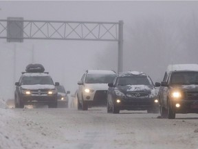 Motorists make their way along highway 40 in Montreal on December 22, 2013 as a winter storm warning has been issued for the region. Quebec is reportedly looking to moving up the mandatory date by which winter tires must be put on all vehicles in the province and increase fines for those who don't follow the rules. According to reports, the Couillard government is expected to table legislation before a holiday break next week.