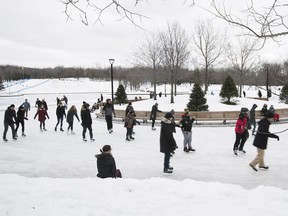 People skate around the refrigerated ice rink at Beaver lake on Tuesday December 27, 2016.