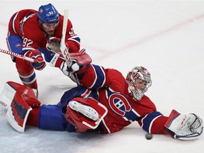 Canadiens goalie Carey Price makes a desperation move as he stops puck with the help of Jonathan Drouin, during overtime Thursday night vs. the Lightning at the Bell Centre.