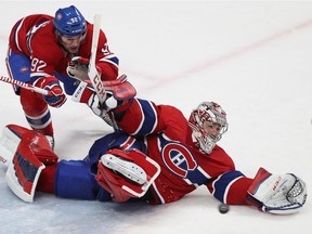 Canadiens goalie Carey Price makes a desperation save with help from teammate Jonathan Drouin during overtime of game against the Tampa Bay Lightning on Jan. 4, 2018 at the Bell Centre. The Canadiens won the game 2-1 in a shootout as Price stopped 44 of the 45 shots he faced.