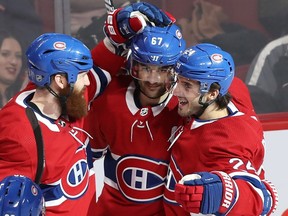 Canadiens' Max Pacioretty, centre, is congratulated by teammates Jordie Benn, left, and Phillip Danault. Montreal's captain has scored in each of the last two goals after going goalless in December.