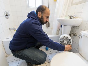 Abdul Waheed Ahmed puts an electric heater in the bathroom of his Park Extension apartment in Montreal Friday January 5, 2018.  In recent days the temperature in the home has been as low as 14C.  (John Mahoney / MONTREAL GAZETTE)