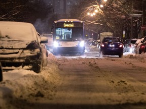 An STM bus waits for a car to pass on Joseph St., clogged by uncleared snow and unmoved vehicles, in Montreal on Monday January 8, 2018. (Allen McInnis / MONTREAL GAZETTE)