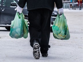 City of Montreal's plastic bag ban does not apply to the de-merged West Island cities such as Dorval where this shopper returns to his car on Sunday.