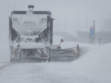 A snowplow works hard at clearing southbound Highway 13 on Saturday, January 13, 2018.