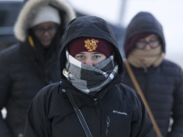 Concordia Stingers fans bundle up against cold as they walk down Pell St. on Sunday, Jan. 14, 2018.