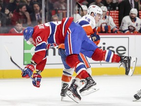 Montreal Canadiens Nicolas Deslauriers is checked by N.Y. Islanders Thomas Hickey during third period of National Hockey League game in Montreal Monday Jan. 15, 2018.