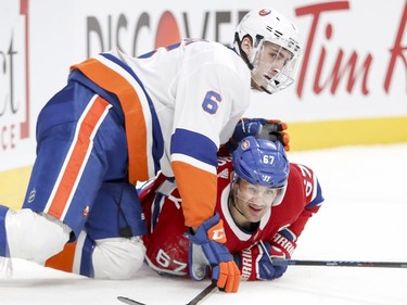 Montreal Canadiens Max Pacioretty watches the play while being pinned down by N.Y. Islanders Ryan Pulock during first period of National Hockey League game in Montreal Monday Jan. 15, 2018.