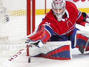 Canadiens goalie Carey Price pokes the puck away from Islanders' Anthony Beauvillier Monday night at the Bell Centre.