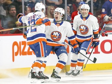 N.Y. Islanders Anthony Beauvillier celebrates goal with teammates Mathew Barzal and Jordan Eberle, right, during first period of National Hockey League game against the Montreal Canadiens in Montreal Monday Jan. 15, 2018.