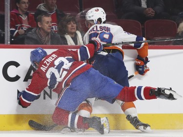 Montreal Canadiens Karl Alzner falls while checking N.Y. Islanders Brock Nelson during second period of National Hockey League game in Montreal Monday Jan. 15, 2018.