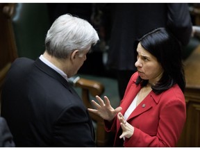Beny Masella, mayor of Montreal West, speaks with Montreal Mayor Valerie Plante at city hall on Jan. 10.