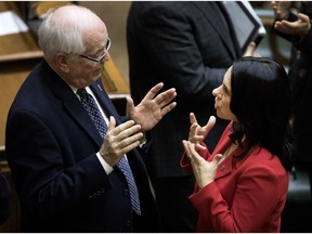 Georges Bourelle, mayor of Beaconsfield, speaks with Montreal mayor Valerie Plante after the Montreal Agglomeration Council meeting at the Montreal city hall last Wednesday.