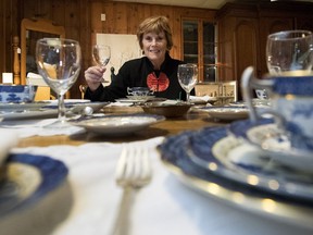 Janet Ellerbeck sits a table set with dinnerware that s for sale at the NOVA boutique, which opened in support of NOVA Hudson last Thursday.