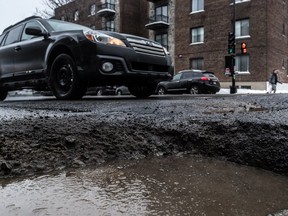 The freeze thaw weather of January caused the formation of potholes in Montreal like this one one Queen Mary Road at Ponsard Avenue on Friday January 19, 2018. (Dave Sidaway / MONTREAL GAZETTE)