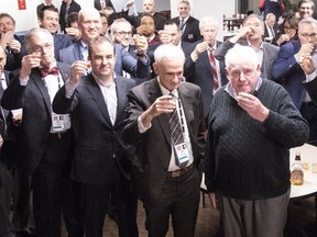 Pat Hickey (front right) with (right to left) Mike Farber, Geoff Molson and Dave Stubbs offer a toast to Red Fisher at the Bell Centre on Saturday, Jan. 20, 2018.