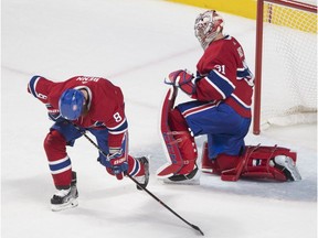 Montreal Canadiens goaltender Carey Price and Jordie Benn react after a goal by Boston Bruins David Pastrnak during third period at the Bell Centre, in Montreal on Jan. 20, 2018.